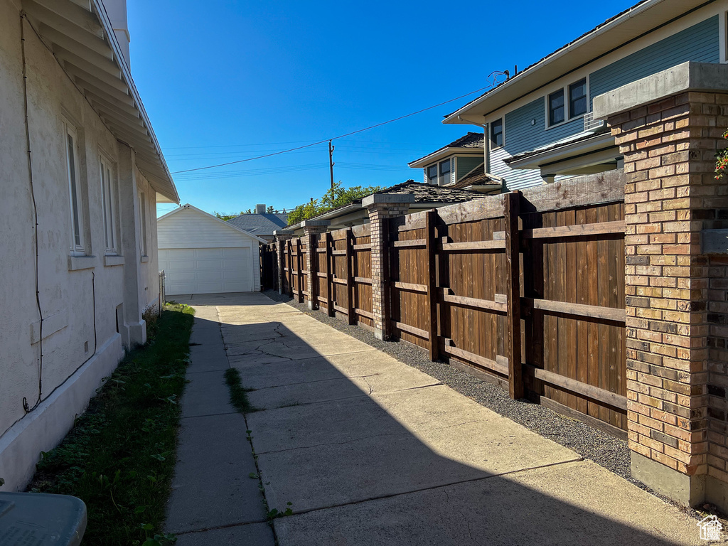 View of patio / terrace featuring a garage and a gate