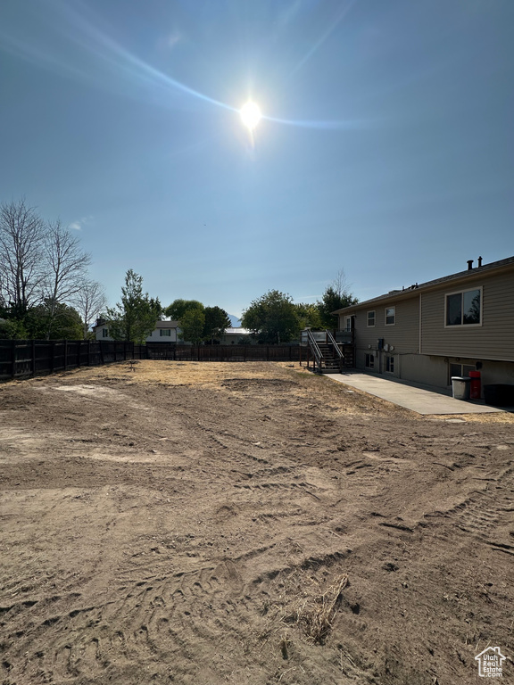 View of yard with a patio area and stairs