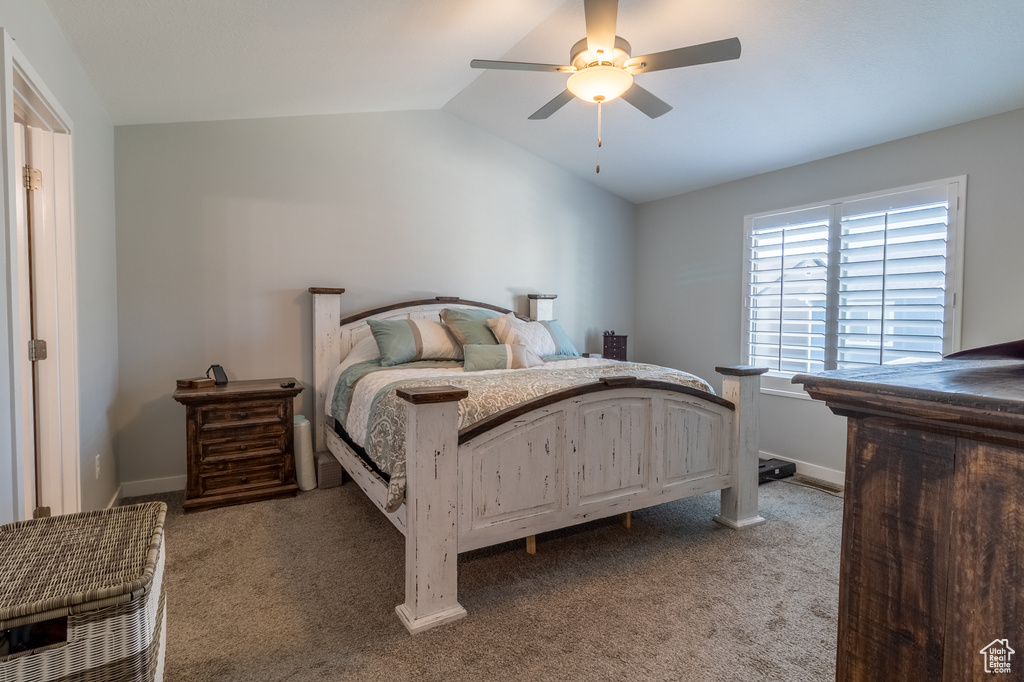 Bedroom with lofted ceiling, light colored carpet, and a ceiling fan