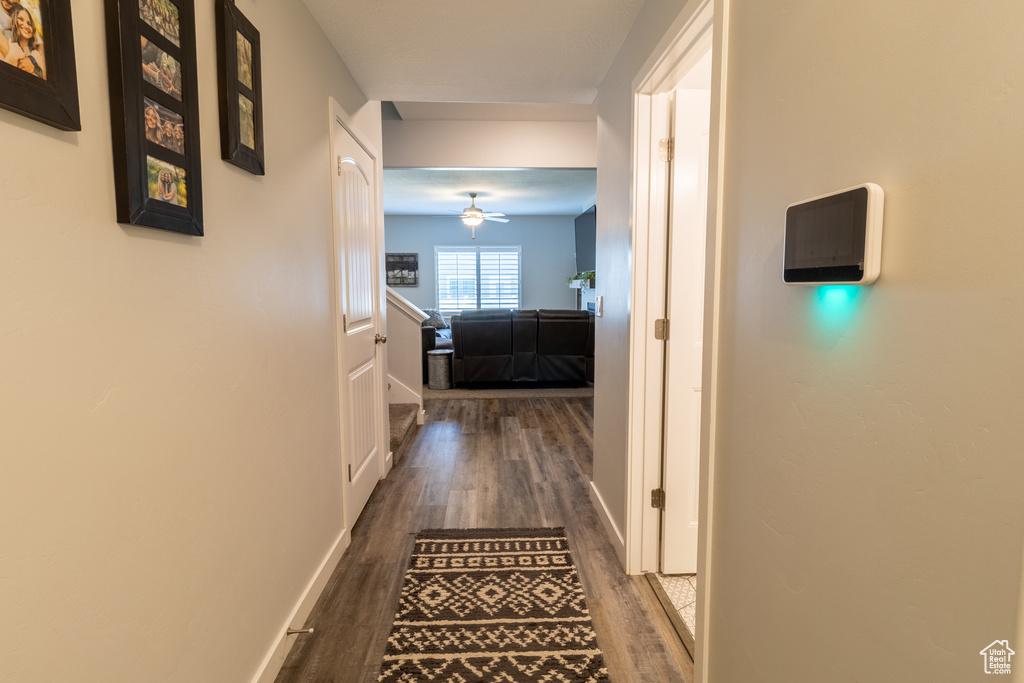 Hall featuring dark wood finished floors and baseboards