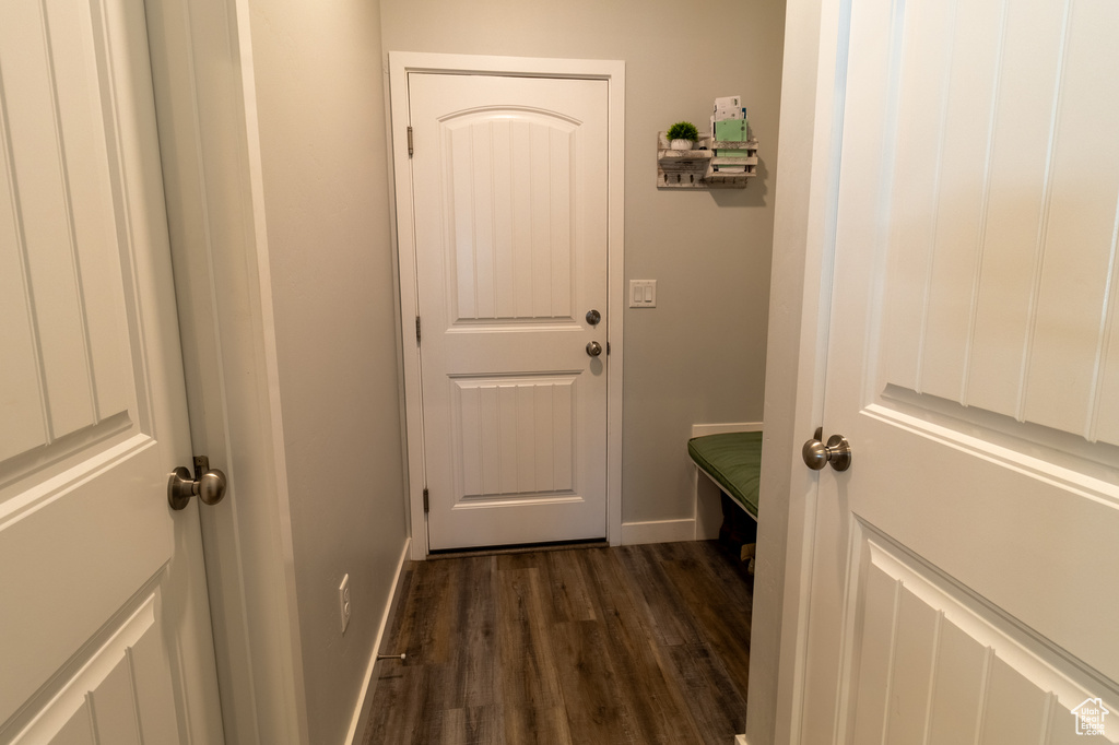 Mudroom featuring dark wood-style flooring and baseboards