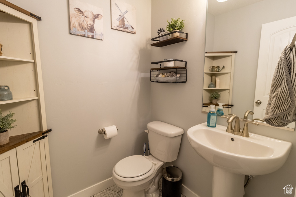 Bathroom featuring baseboards and tile patterned floors