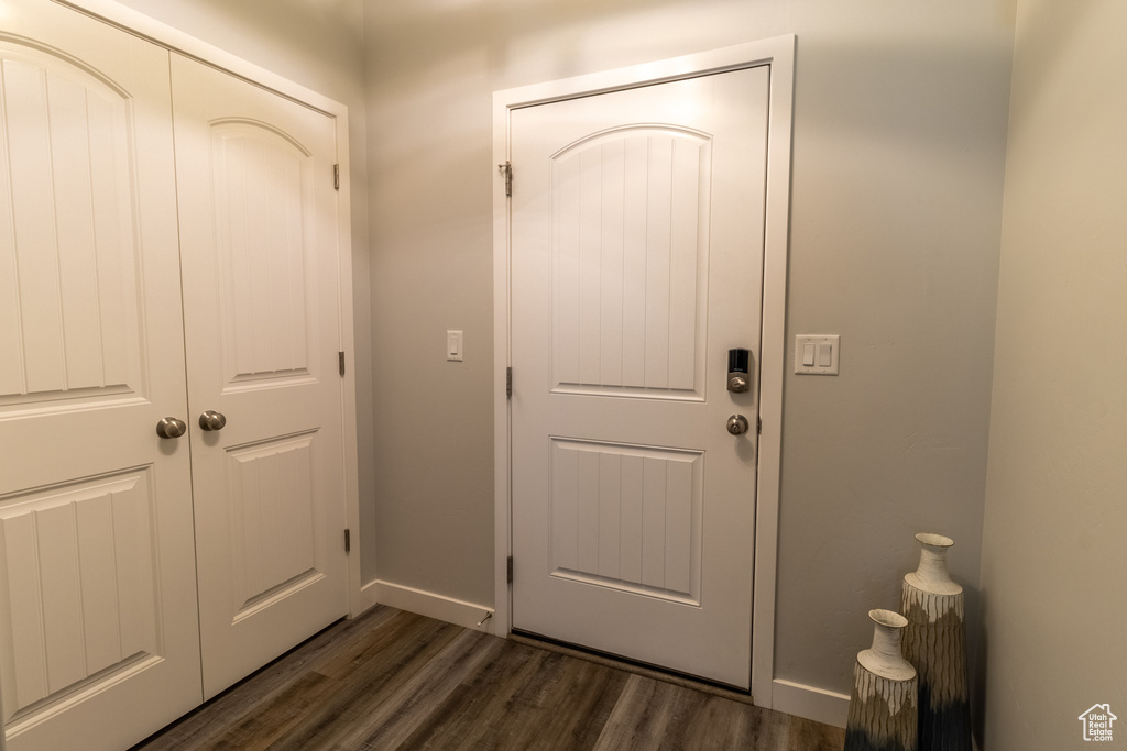 Entryway with dark wood-style floors and baseboards