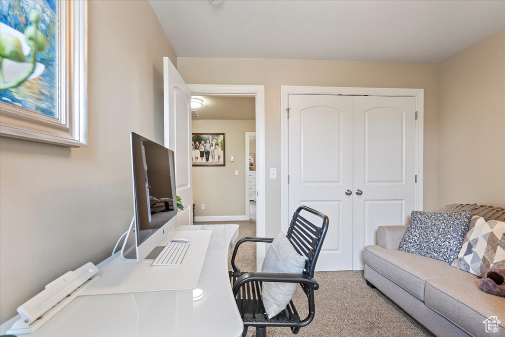 Carpeted office space with baseboards