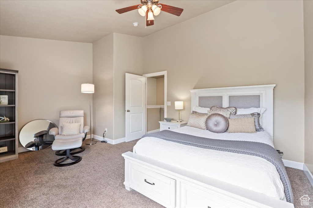 Carpeted bedroom with baseboards and ceiling fan