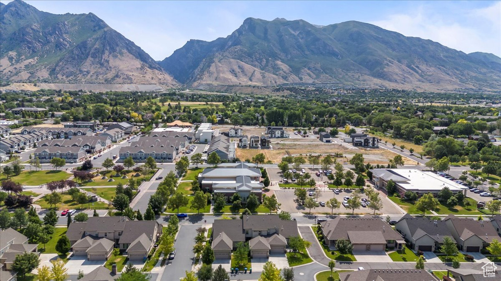 Aerial overview of property\'s location featuring nearby suburban area and a mountain backdrop
