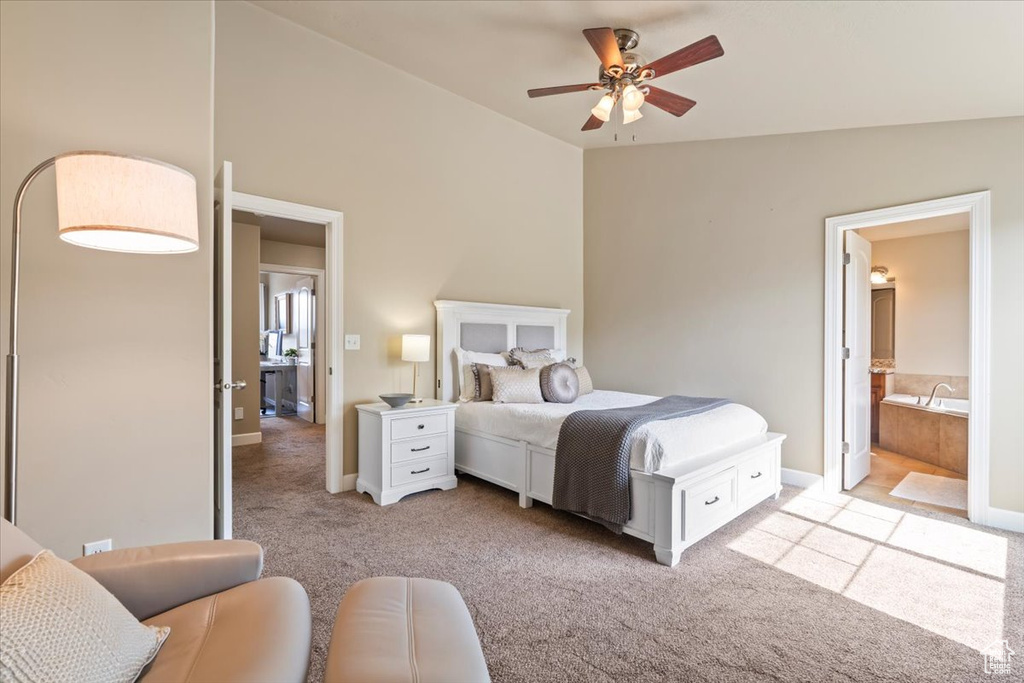 Bedroom featuring light carpet and connected bathroom
