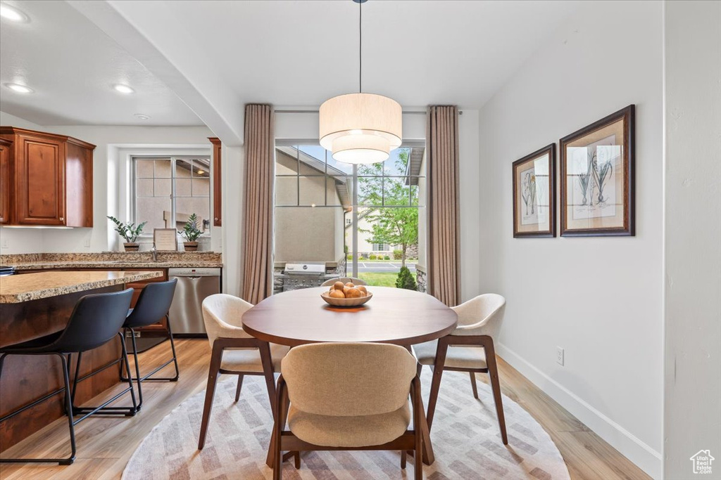 Dining space featuring light wood-style floors and recessed lighting