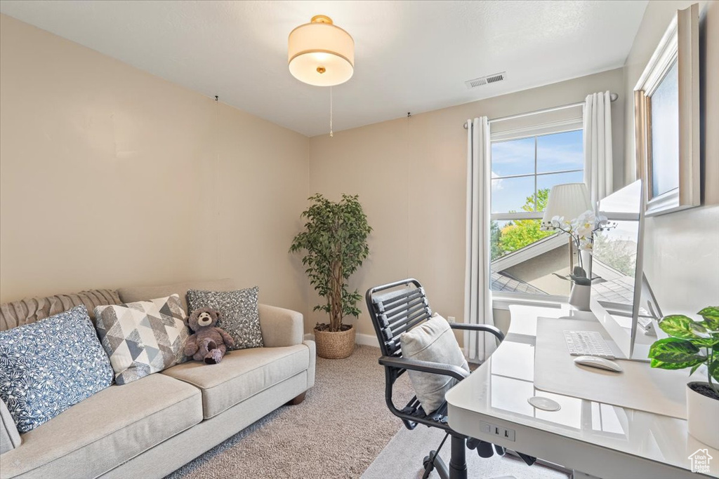 Carpeted office space with baseboards
