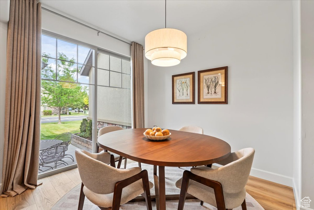 Dining area featuring light wood-style flooring and baseboards