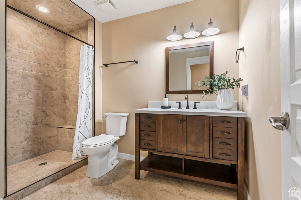 Full bathroom featuring vanity and tiled shower