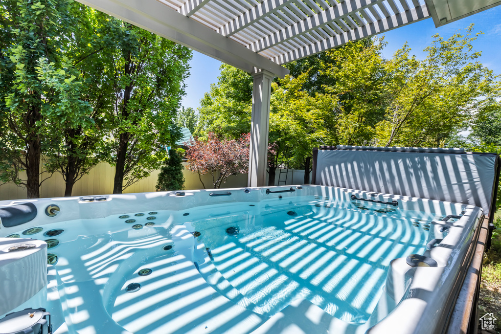 View of patio / terrace featuring a pergola and a hot tub