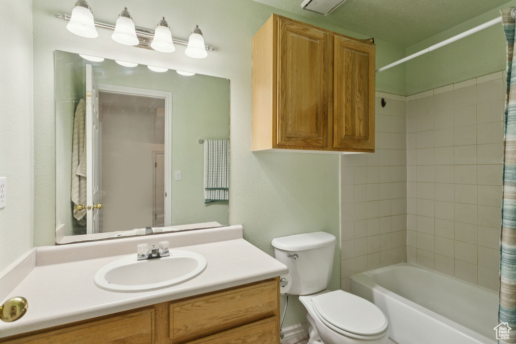 Full bath with vanity and shower / bath combination with curtain