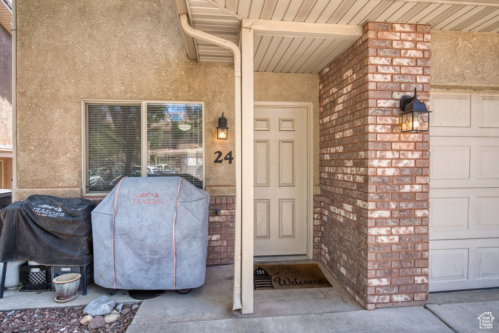 View of exterior entry featuring stucco siding
