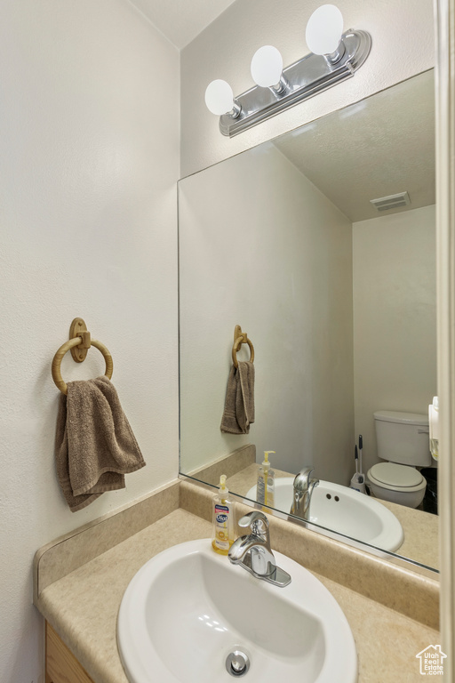 Bathroom featuring vanity and toilet