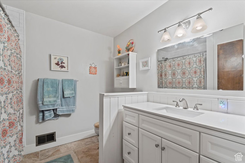 Full bathroom featuring vanity and curtained shower