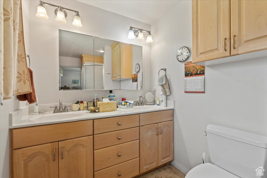 Bathroom with double vanity and a shower with shower door