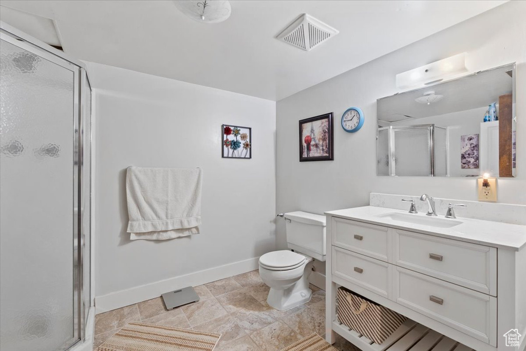Bathroom with a shower stall and vanity