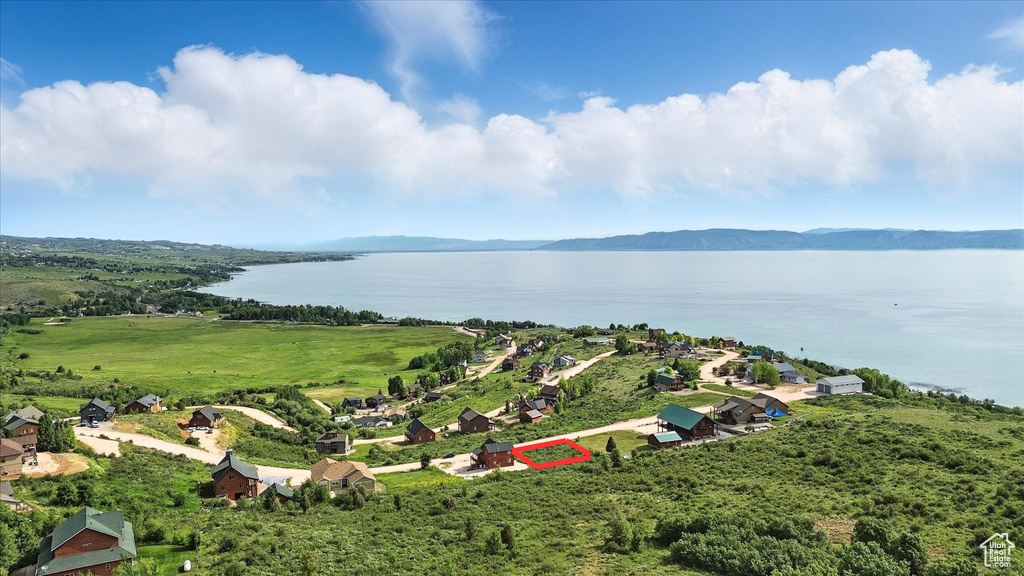 Aerial view of property and surrounding area with a water and mountain view and property boundaries highlighted