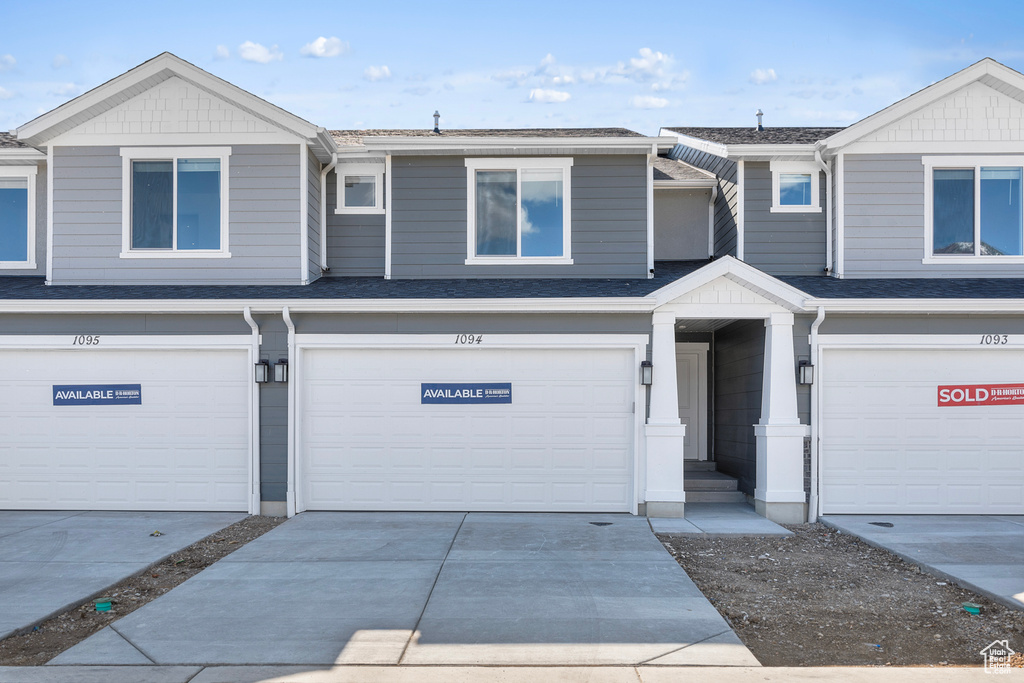 Townhome / multi-family property featuring an attached garage and driveway