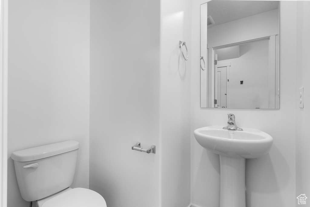 Half bathroom with toilet and a sink