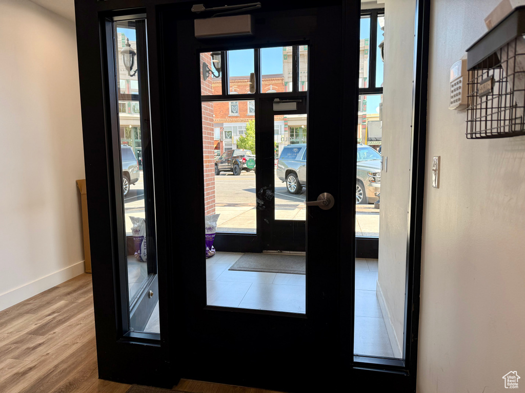 Entryway featuring wood finished floors, french doors, and a wall mounted air conditioner
