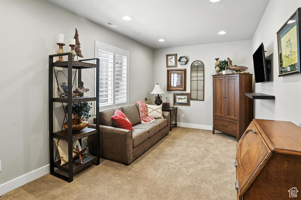 Living room with light carpet and recessed lighting