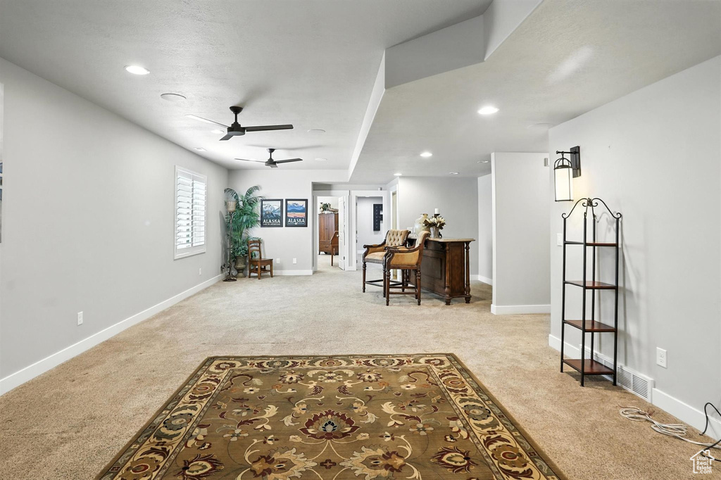Living room featuring carpet, ceiling fan, and recessed lighting