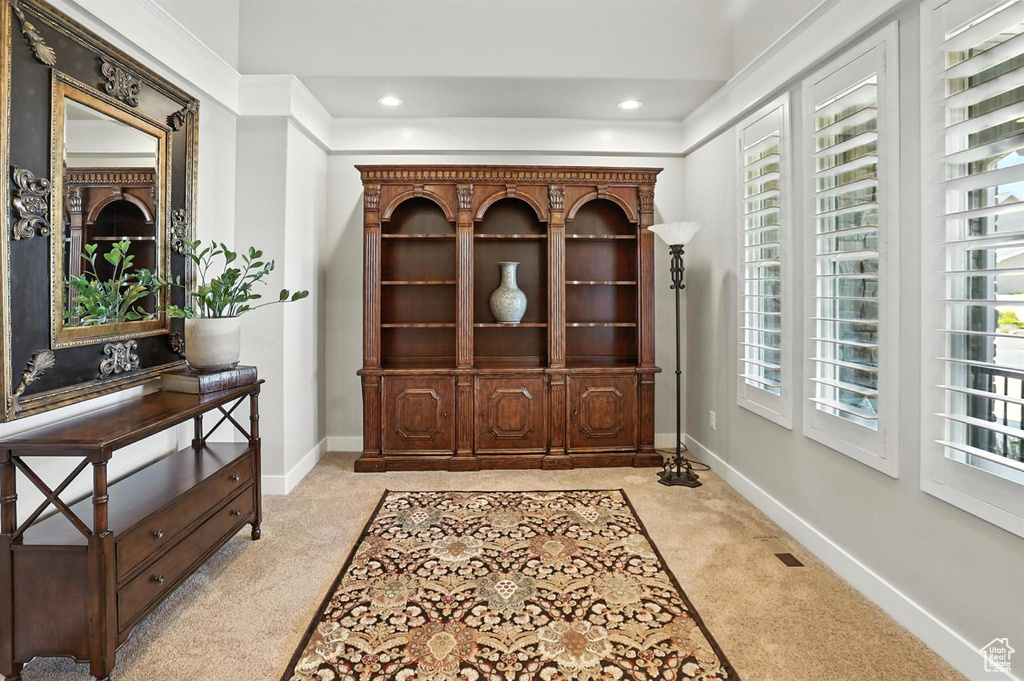 Foyer with light colored carpet and recessed lighting