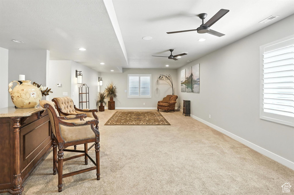 Living area with recessed lighting, ceiling fan, and carpet flooring