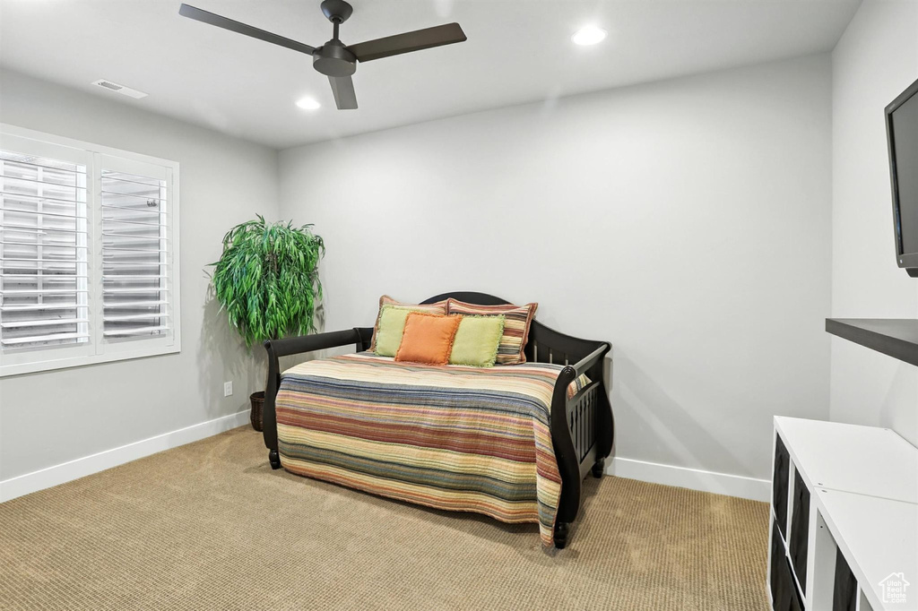 Carpeted bedroom featuring recessed lighting and a ceiling fan