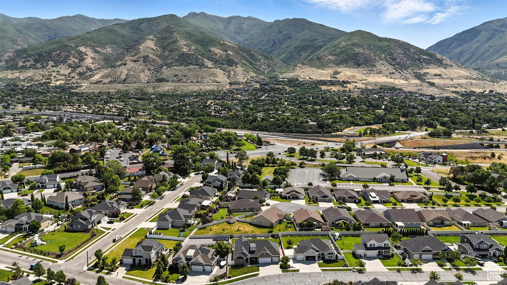Aerial view of property\'s location featuring a mountain backdrop and nearby suburban area