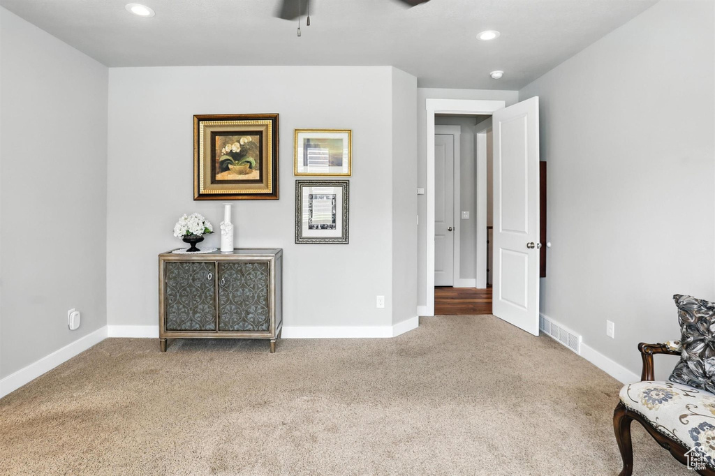 Living area with carpet flooring, ceiling fan, and recessed lighting