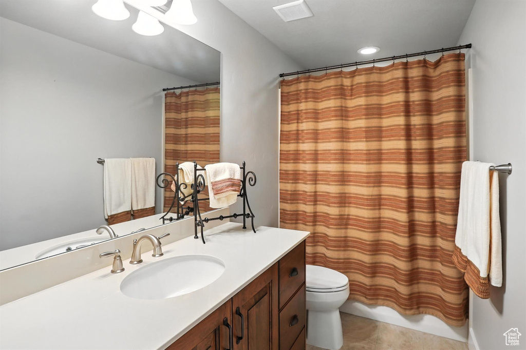 Bathroom featuring vanity, tile patterned flooring, a shower with curtain, and recessed lighting