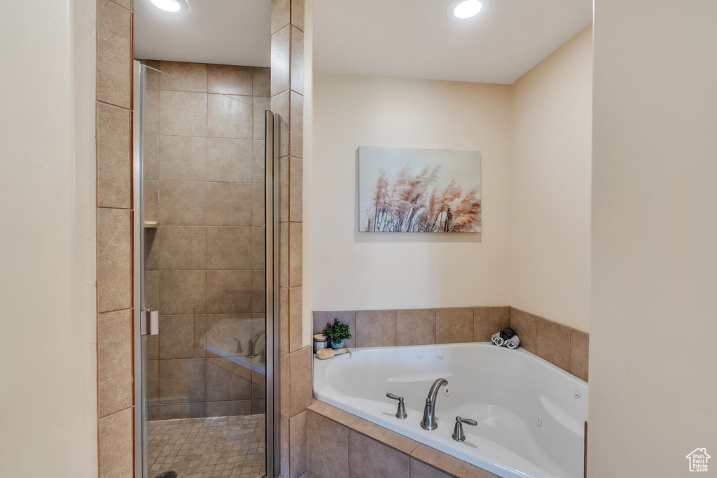 Full bathroom featuring a tub with jets, a shower stall, and recessed lighting