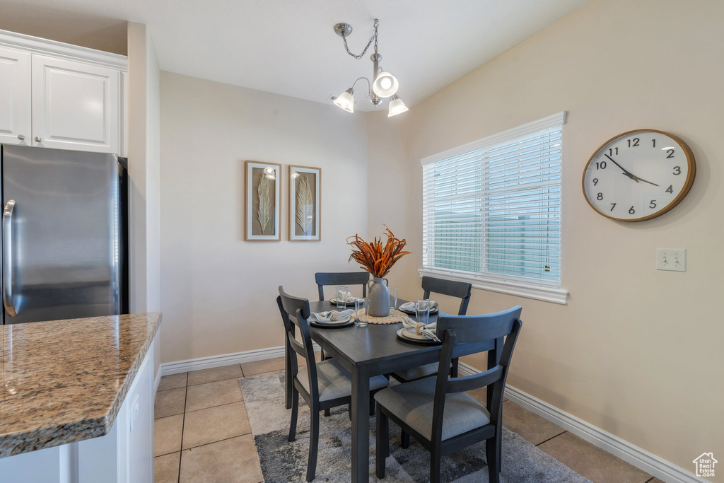 Dining space featuring light tile patterned flooring and baseboards