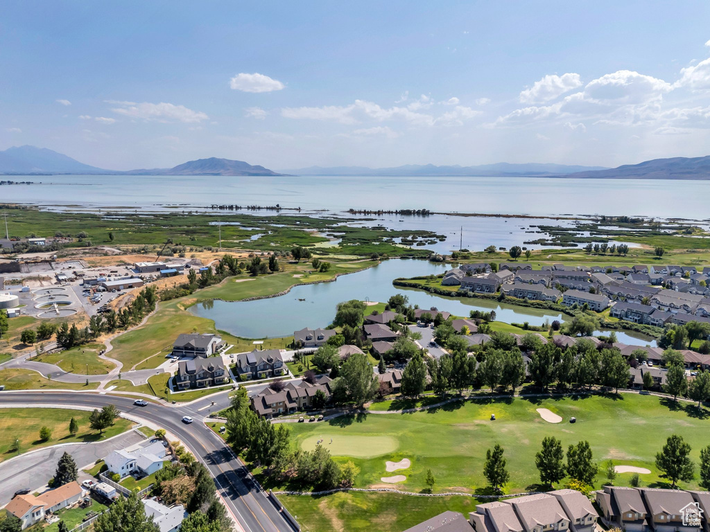 Aerial overview of property\'s location featuring nearby suburban area, a water and mountain view, and a golf course