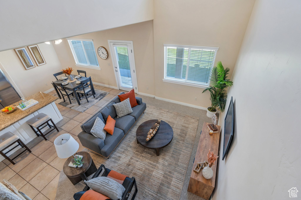 Living area featuring tile patterned floors and baseboards