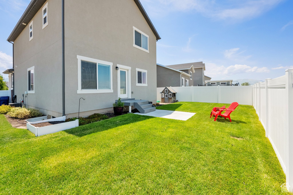 Back of house featuring a fenced backyard and stucco siding