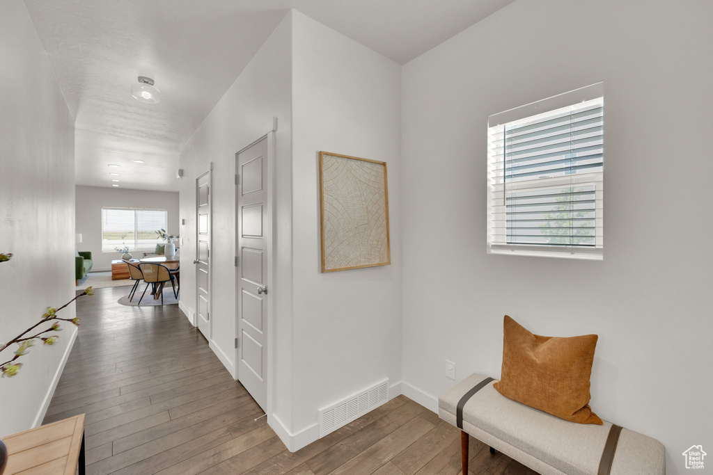 Hall featuring wood finished floors and baseboards
