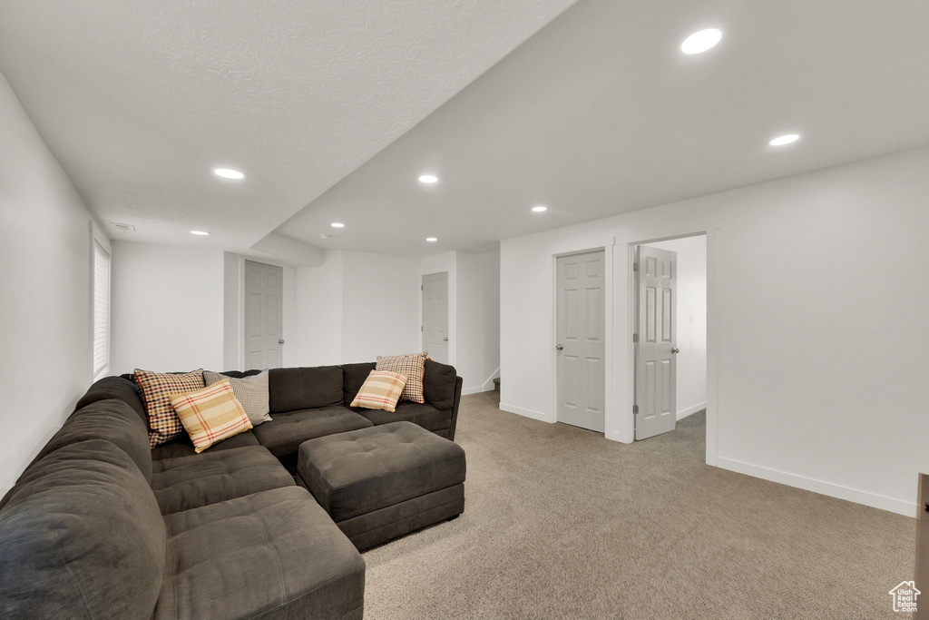 Carpeted living room featuring recessed lighting