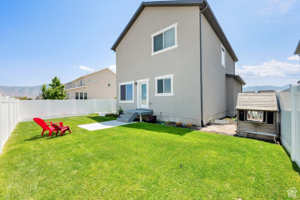 Back of property featuring a fenced backyard and stucco siding