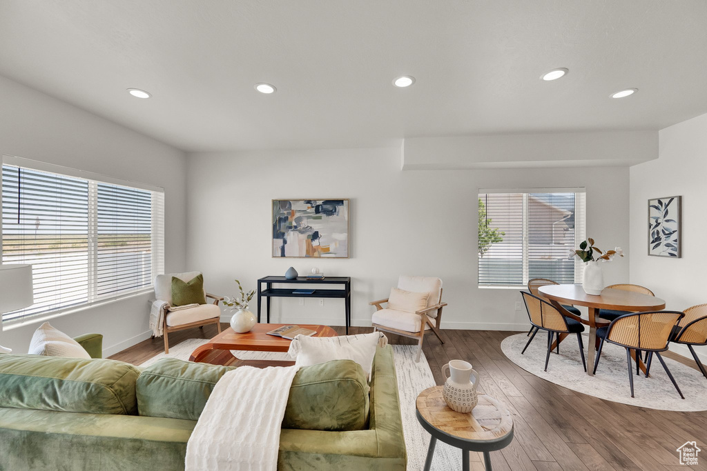 Living room with recessed lighting and dark wood-style flooring