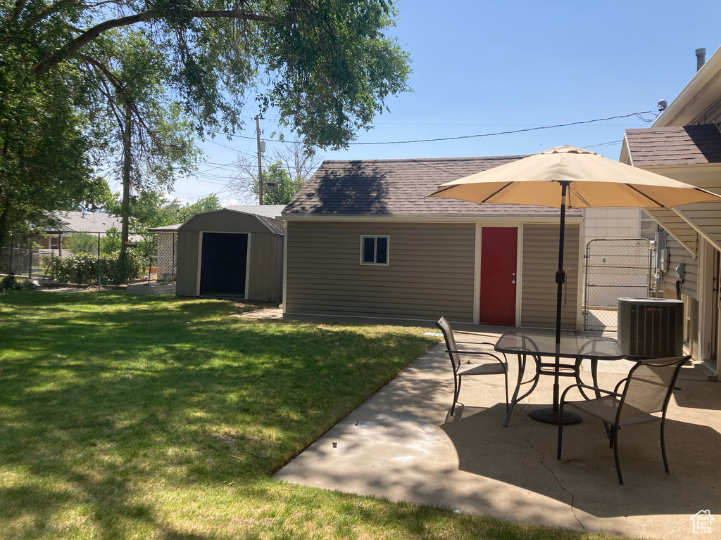 View of yard featuring a patio, a shed, and outdoor dining space
