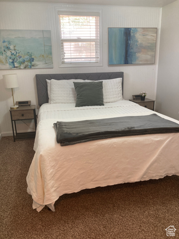 Carpeted bedroom featuring baseboards