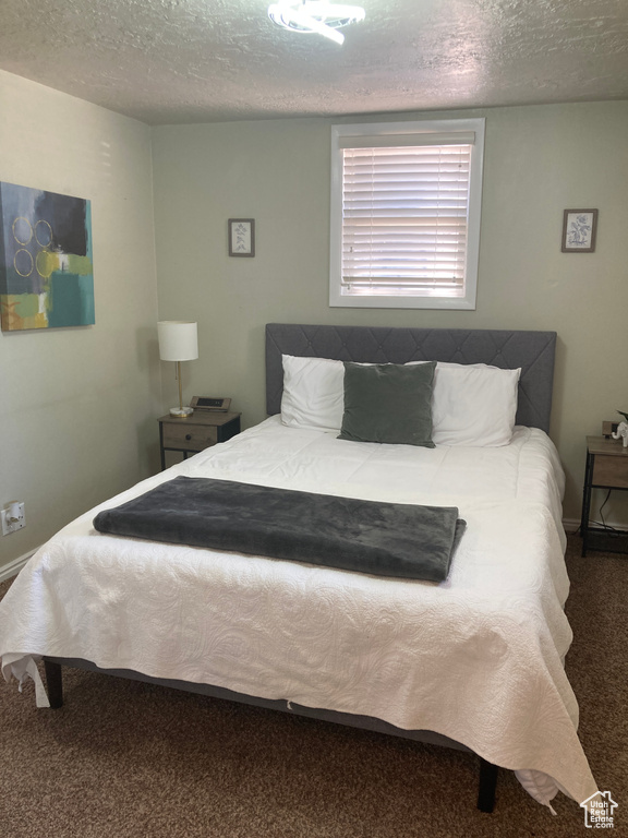 Carpeted bedroom with a textured ceiling