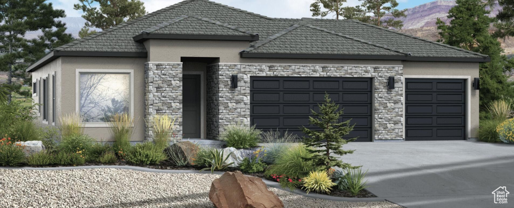 View of front facade featuring stucco siding, a garage, driveway, a tiled roof, and stone siding