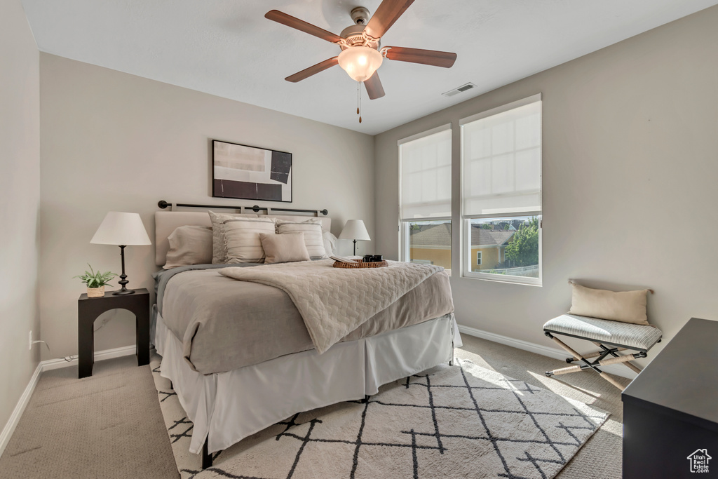 Bedroom featuring light colored carpet and a ceiling fan