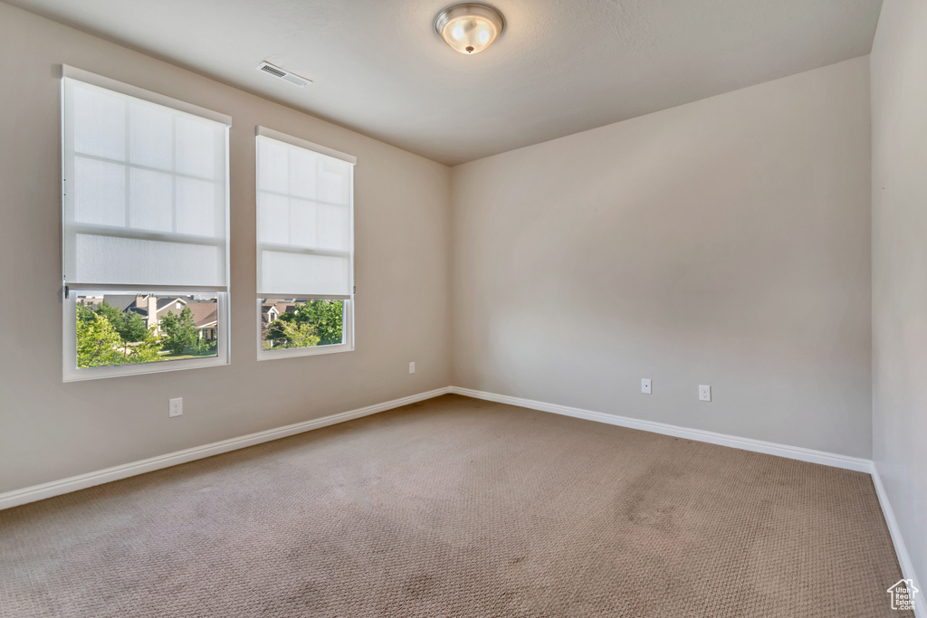 Spare room featuring carpet flooring