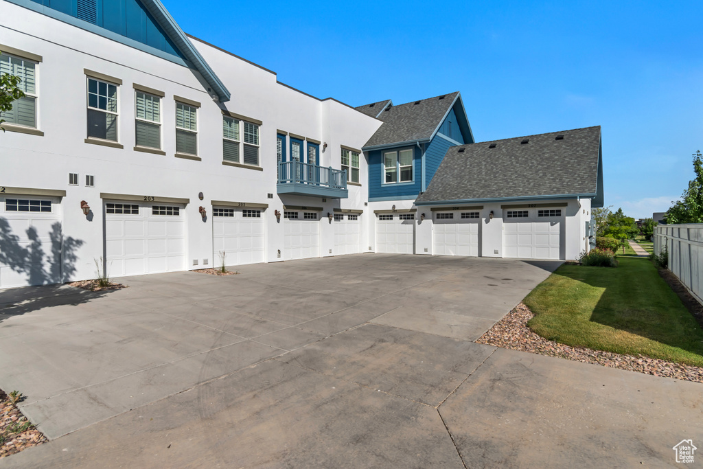 View of home's exterior with driveway, a residential view, and a garage
